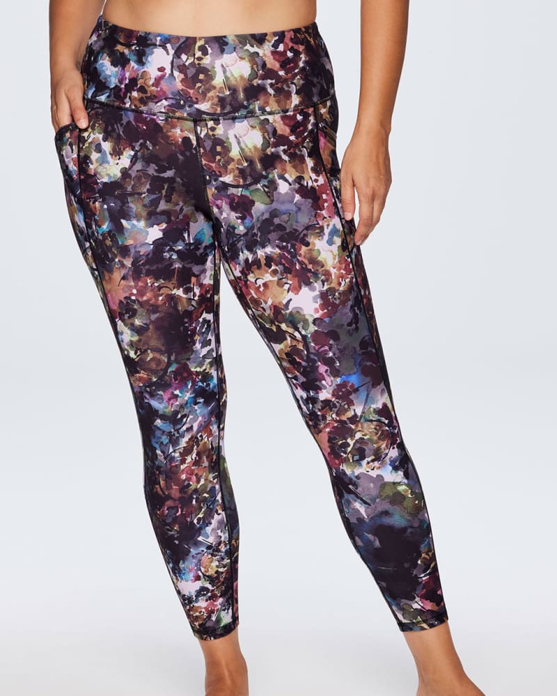 Front of a model wearing a size 1X Botanical Floral Legging With Pockets in Multi by RBX Active. | dia_product_style_image_id:244867